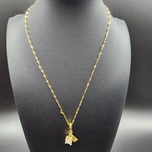 Gold plated travel themed necklace with suitcase and postcard charm